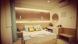 A modern hotel room with a large bed, bedside tables, a seating area, and a wall-mounted heater. - Hai Hotel (Larnaca)