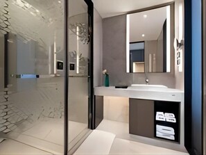 A modern bathroom with a glass shower enclosure, a large mirror, and a white sink with a black cabinet. - Hampton by Hilton Technology City (Hangzhou)