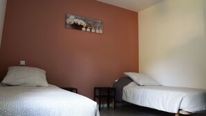 A bedroom with two beds, a small table, a nightstand, and a painting on the wall. - New residence, The Manaka, The Rose of the Sands, calm and rest (lamalou les bains)