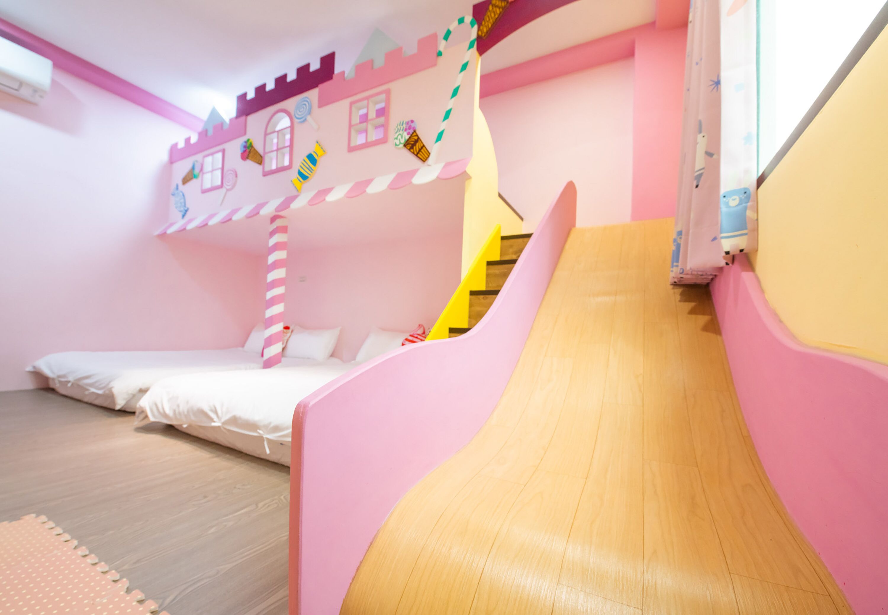 A children's play area with bunk beds and a slide.