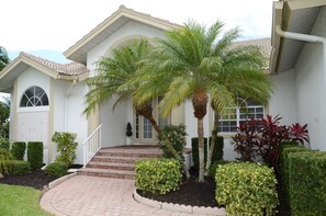 Classic home with a beautifully maintained front yard and lush landscaping.