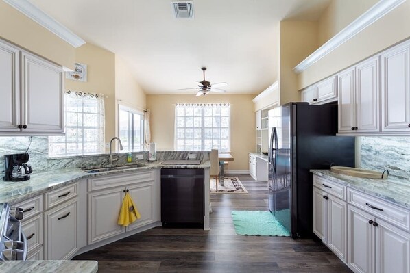 Enjoy cooking in this well-equipped kitchen with a central island, sink, and dishwasher.