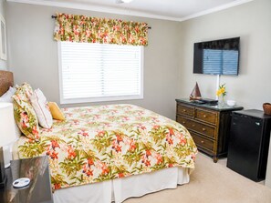 A bedroom with a bed, a dresser, a television, and a window with blinds. - Experience Tilghman Beach and Racquet Club Unit 160B! Second Row, Pools, Tennis, Close to Main Street! (North Myrtle Beach)