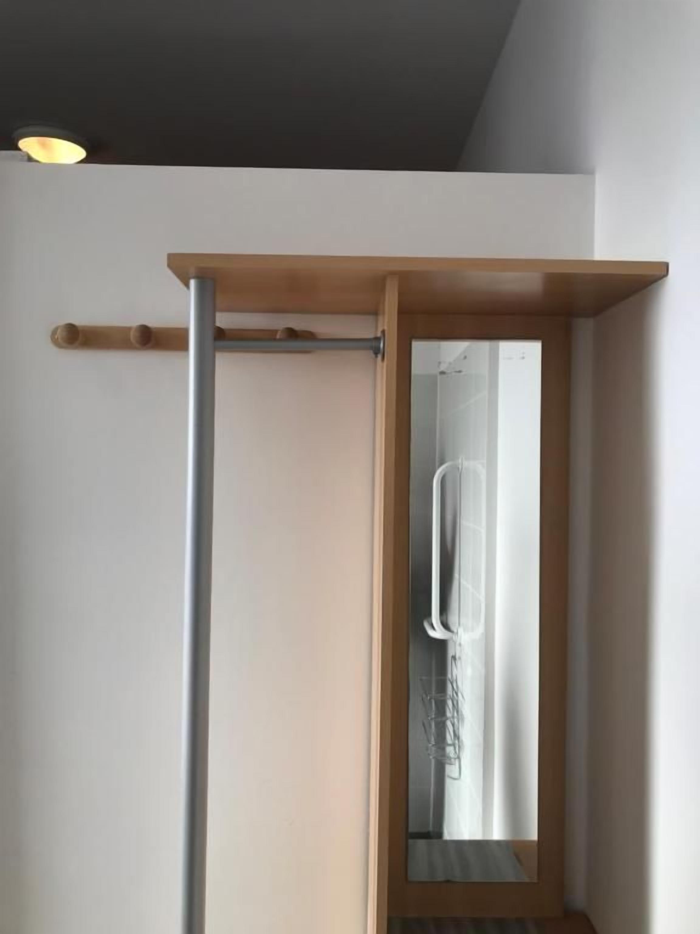 A doorway with a wooden frame and a metal handle.