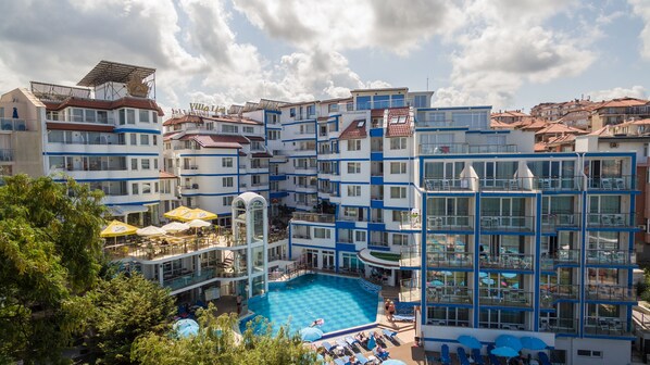 A hotel with multiple balconies, a swimming pool, and outdoor seating areas. - Villa List Hotel (Sozopol)