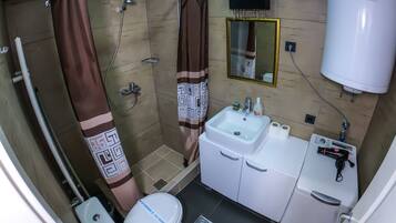 Classic Apartment | Bathroom | Shower, hair dryer, towels, soap