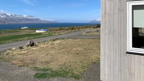 A wooden building with a view of a lake and mountains. - Sunnuhlid houses (Akureyri)