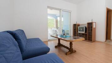 Apartment, 1 Bedroom, Balcony, Sea View | Living area | Flat-screen TV