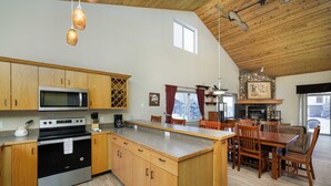 A spacious kitchen with wooden cabinets, a built-in microwave, and a large island.