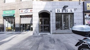 A storefront with a sign reading "BIBA" above a metal gate. - Hemeras Boutique House Aparthotel Duomo 6 (Milan)