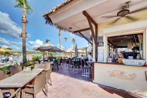 Guests can enjoy meals and drinks in a relaxed atmosphere under the shaded canopy.