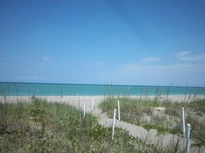 Enjoy a serene beach experience with access to calm turquoise waters and a natural, undeveloped shoreline.