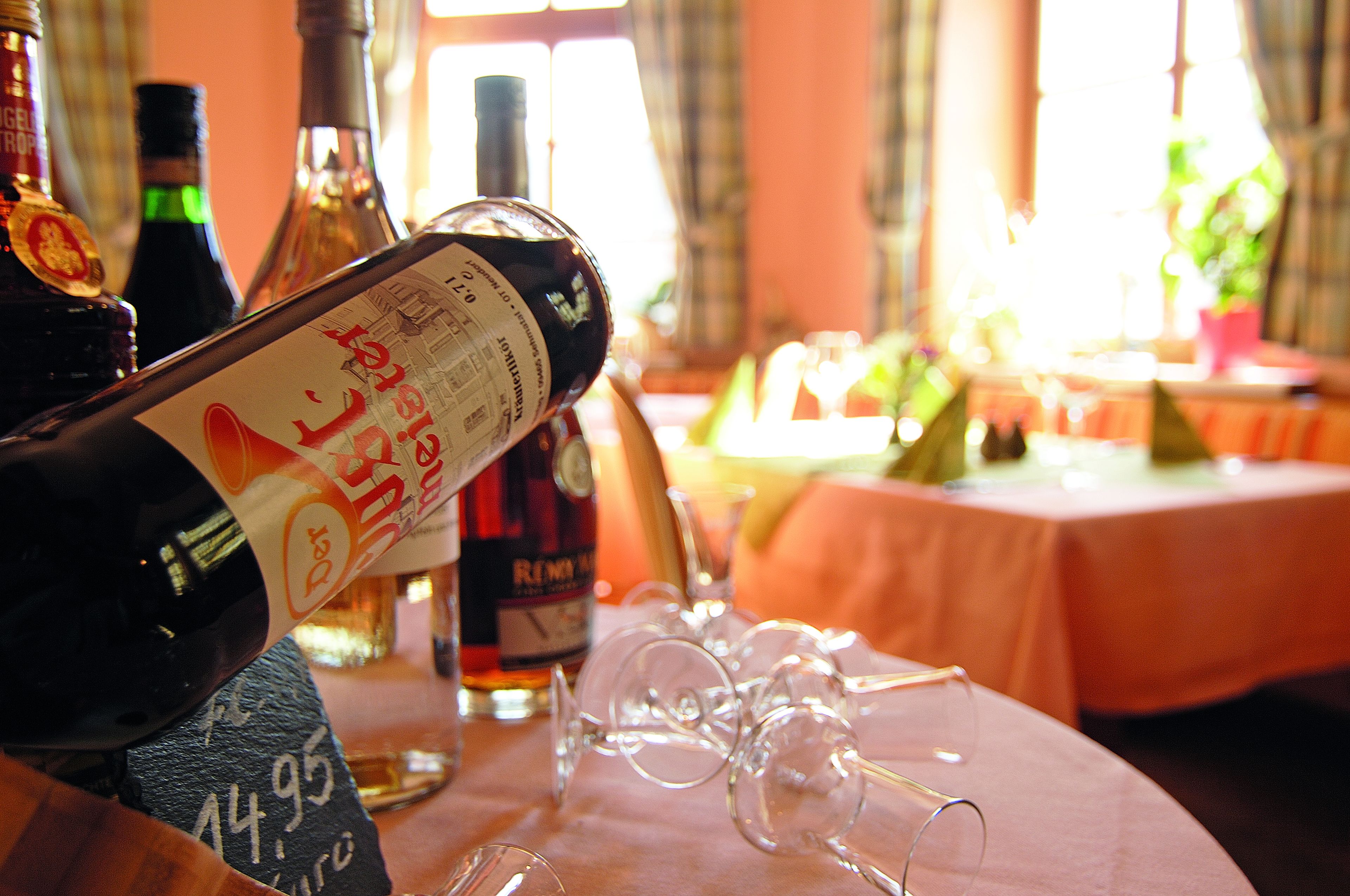 A table with wine bottles and glasses, suggesting a dining or social setting.