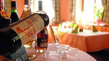A table with wine bottles and glasses, suggesting a dining or social setting.