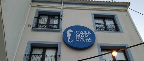 Un bâtiment sur lequel on peut lire l’inscription suivante : « CASA DEL MAD HOSTAL RESTOBAR ».