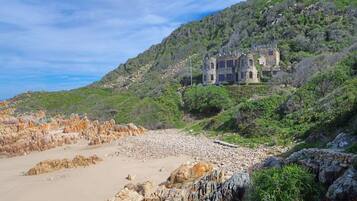 Perched on a hillside, this historic building offers a traditional architectural style with multiple windows.