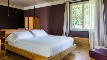 A modern bedroom with a wooden bed, a wardrobe, and a window with curtains.