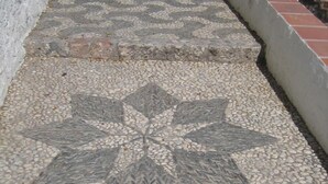 A stone staircase with a geometric pattern on the steps.