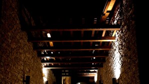 A stone-walled corridor with wooden steps leading to a higher level. - Domina Borgo degli Ulivi - Lake Garda (Gardone Riviera)