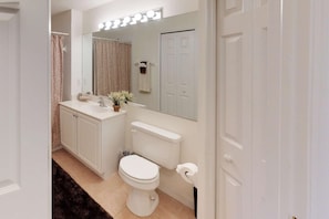 A bathroom with a white sink, mirror, and toilet. - 10127 Colonial Country Club Blvd #1607 (Fort Myers)