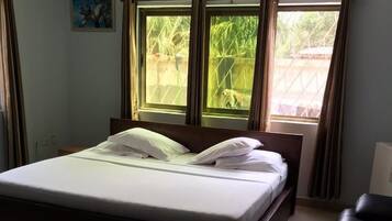 Desk, iron/ironing board, bed sheets