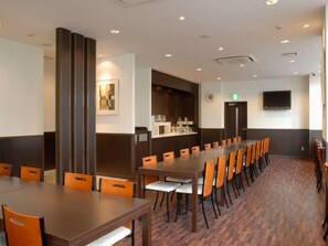 A conference room with a long table, multiple chairs, a television, and a microwave. - Ab Hotel Mikawa Anjo Minamikan (Anjo)