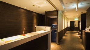 A modern hotel reception area with a long counter, a digital check-in kiosk, and a clean, well-lit interior. - Super Hotel Tokyo Akabane-Eki Higashiguchi Ichibangai (Tokyo)