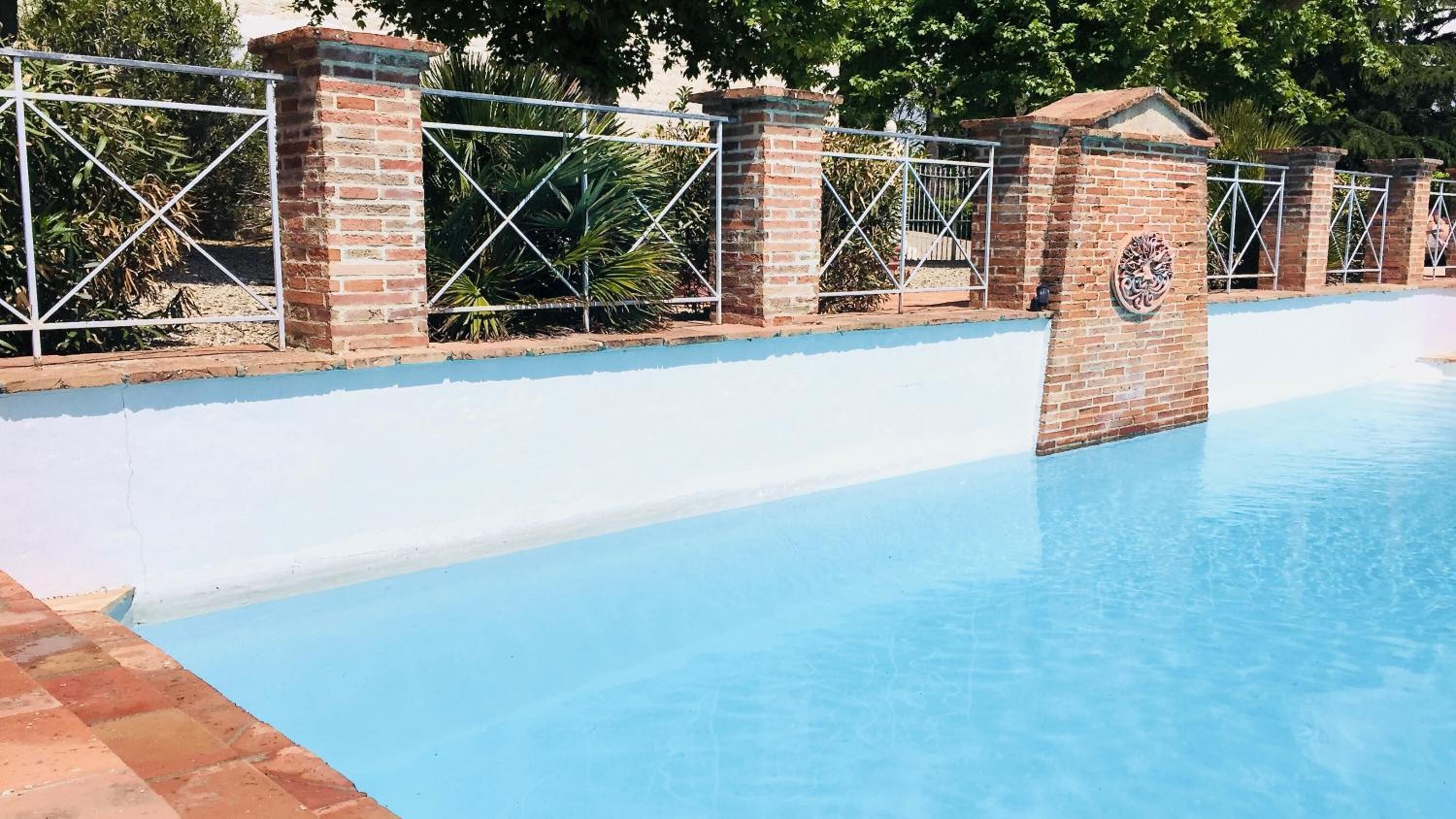 季節性室外游泳池，提供泳池遮陽傘和日光浴躺椅