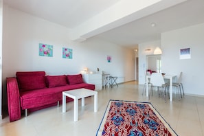 Deluxe Apartment, Sea View (1) | Living area | Flat-screen TV