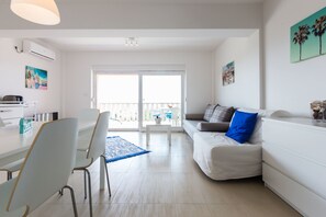 Deluxe Apartment, Sea View | Living room | Flat-screen TV