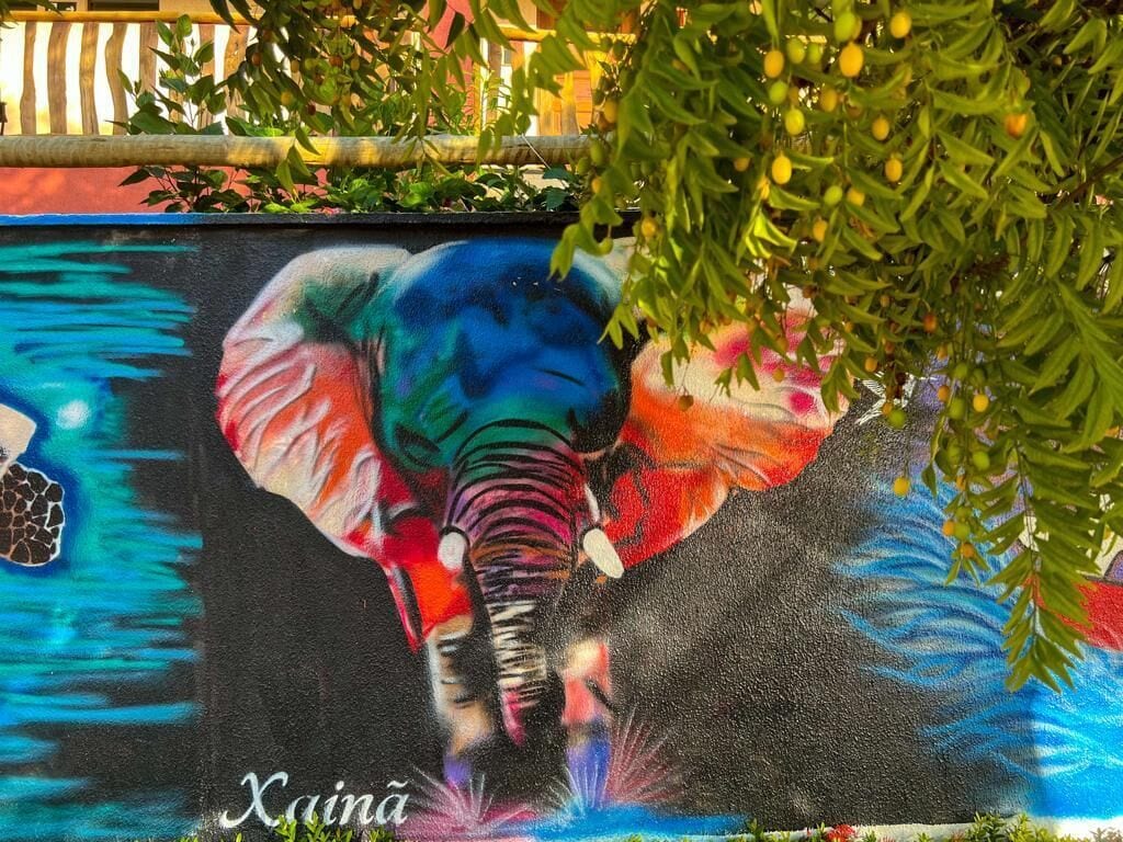 A colorful mural of an elephant on a wall.