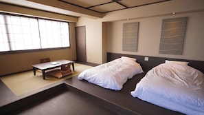 A room with a bed, a desk, and a window. - Atami Tsukiemon (Atami)