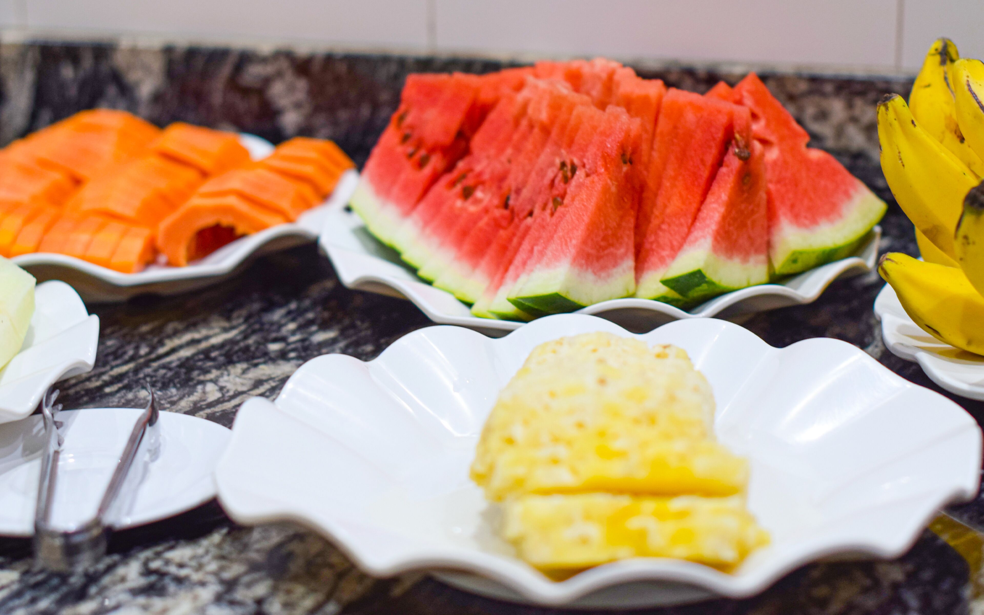 A buffet with various fruits and vegetables.