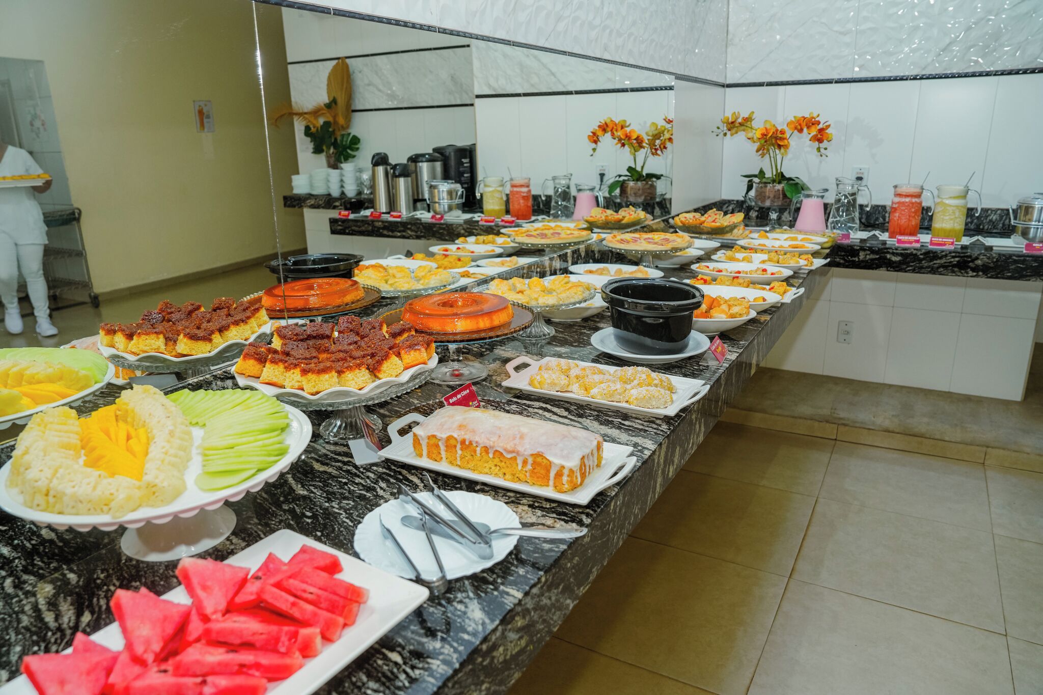 A buffet with various food items and beverages.