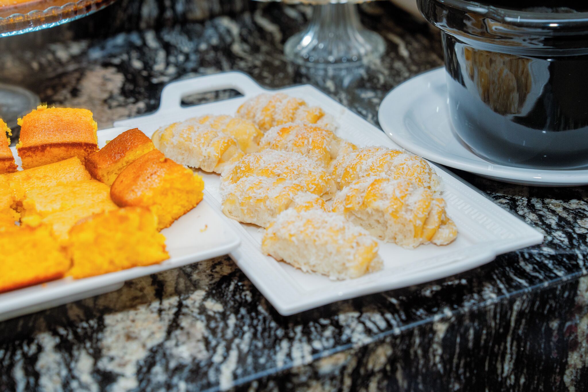 A plate of food with various dishes on a marble countertop.