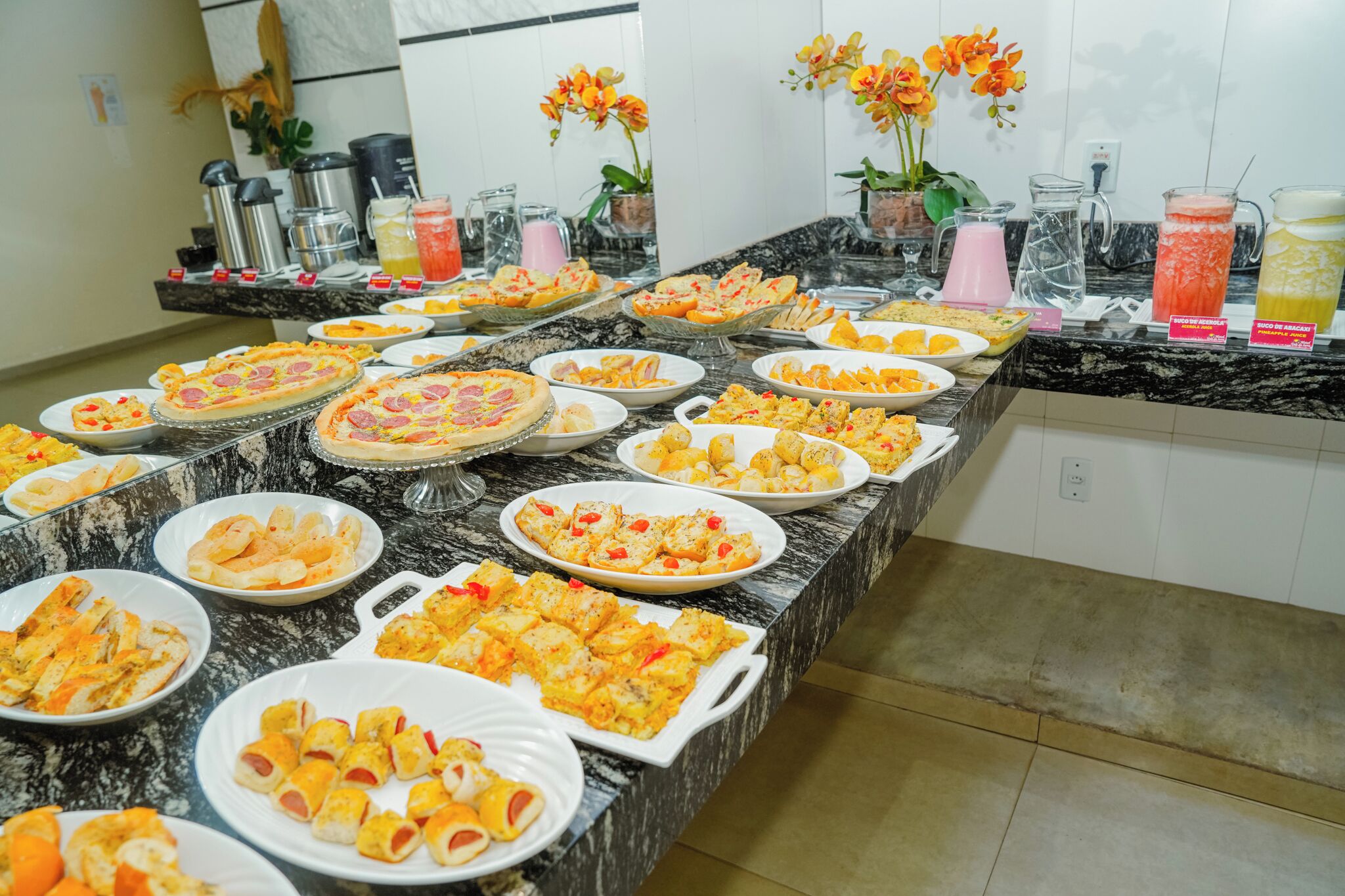A buffet table with various dishes and drinks.