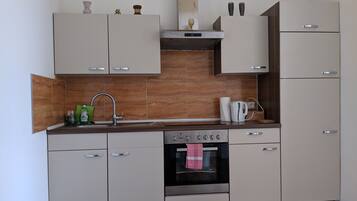 Apartment, Garden View | Private kitchen | Full-size fridge, microwave, oven, stovetop