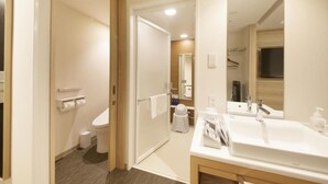 A hotel bathroom with a toilet, sink, mirror, and towel rack. - Richmond Hotel Tenjin Nishidori (Fukuoka)