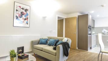 Business Apartment, Multiple Beds | Living area | 50-inch Smart TV with digital channels, TV