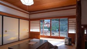 A traditional Japanese room with tatami flooring, a low table, and sliding doors. - Koyasan Sainan-In (Koya)