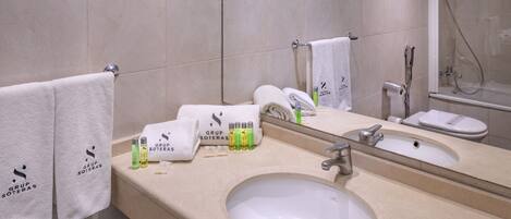 A bathroom with a sink, mirror, and towel rack.