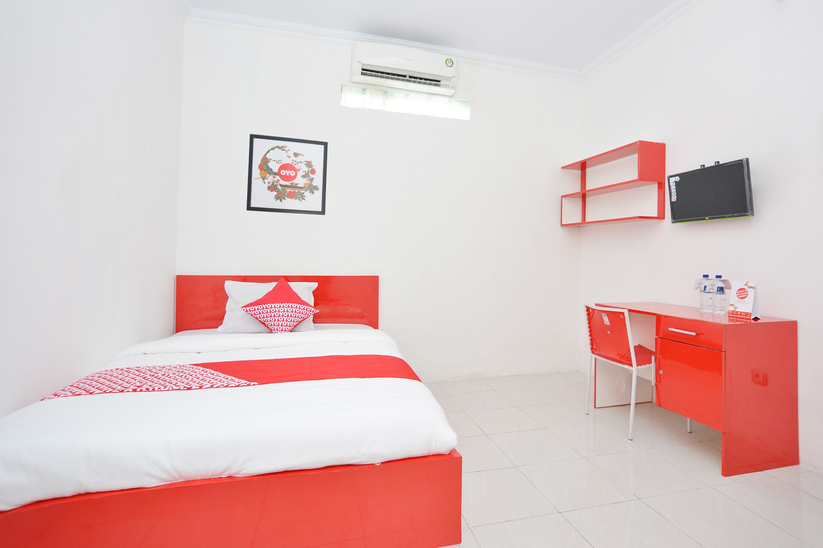 A room with a bed, a desk, and a chair.