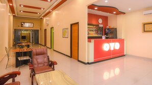 A hotel lobby with a reception desk, seating area, and a dining area. - Collection O Banda Aceh near Masjid Raya Baiturrahman formerly Hotel Mulana (Banda Aceh)