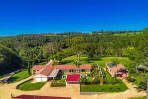 A large estate with multiple buildings, a swimming pool, and a well-maintained lawn.