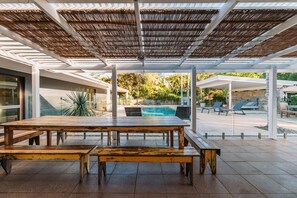 An outdoor patio with a pool, wooden furniture, and a pergola. - 🌿 Tin Horse Ranch – Private Byron Hinterland Estate | Pool | Sleeps up to 20 (Pearces Creek)
