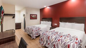 A hotel room with two beds, a desk, a chair, a wardrobe, and a mirror. - Red Roof Inn Houston - Willowbrook (Houston)