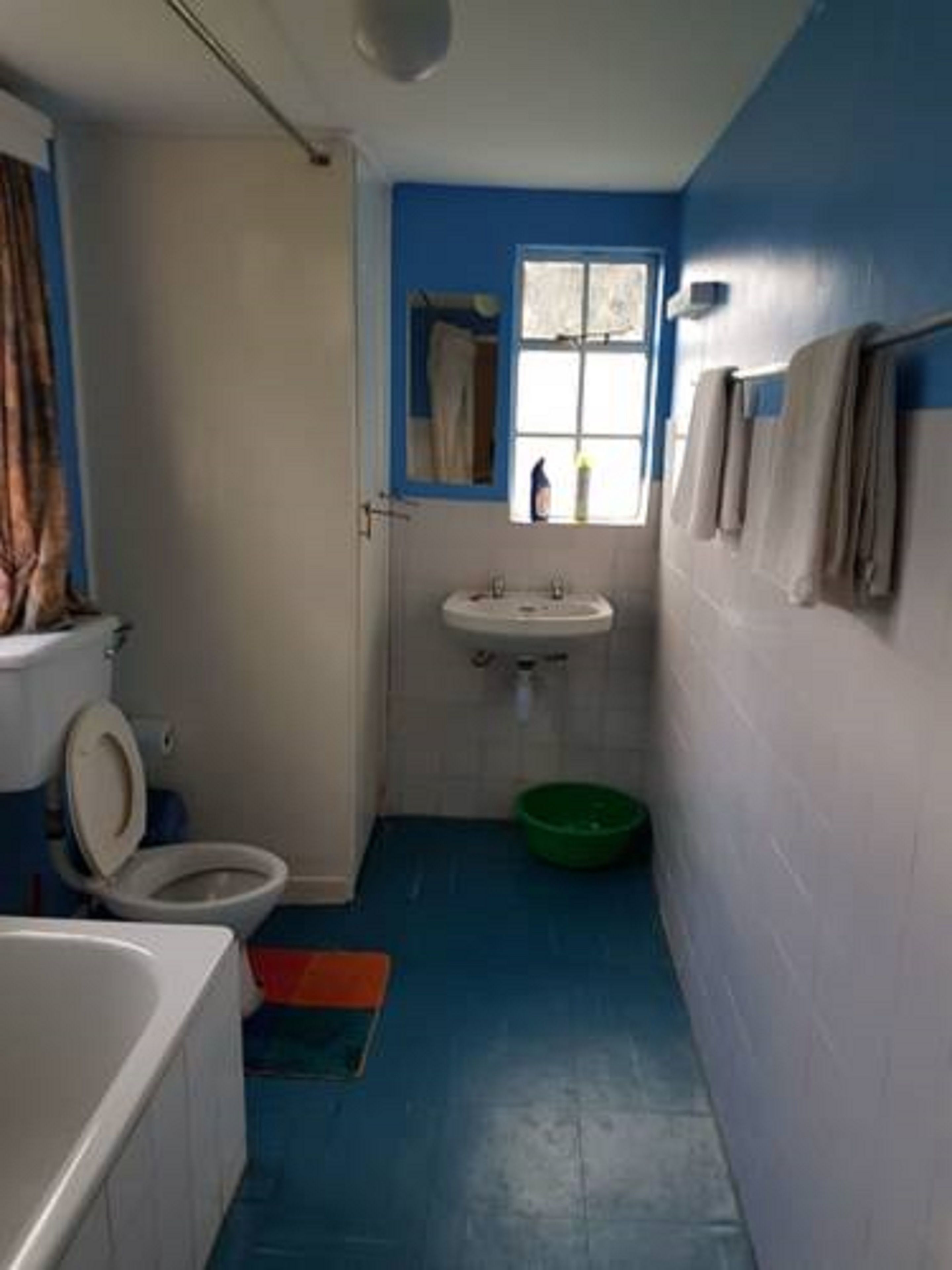 A small bathroom with a toilet, sink, and bathtub.