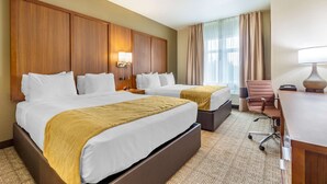 A hotel room with two beds, a desk, a chair, and a large window with curtains. - Comfort Inn & Suites Lakewood by JBLM (Lakewood)