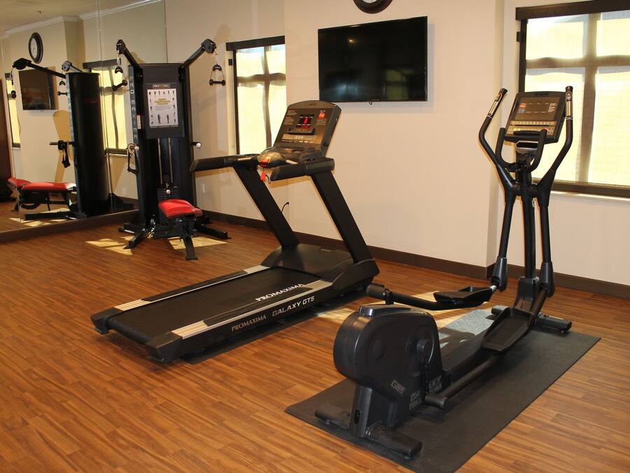 A gym with treadmills, a stationary bike, and weight machines.