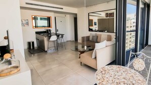 A modern apartment with a kitchen, dining area, and a balcony with a view. - Design Apt Parking Included 2BDR TL30 (Tel Aviv)